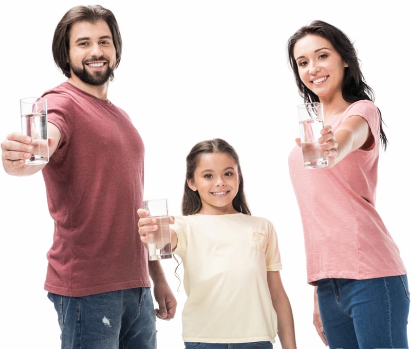 Family holding glasses of water out